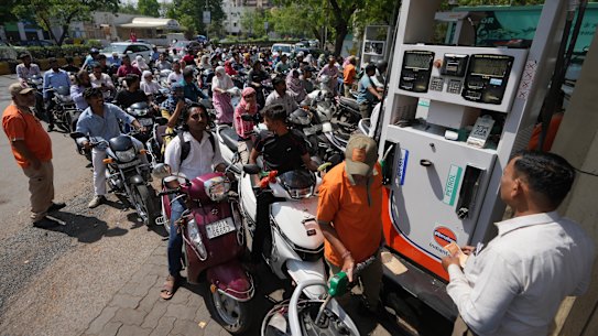 Drivers line up to get fuel at a pump in Ahmedabad, India, this week.
