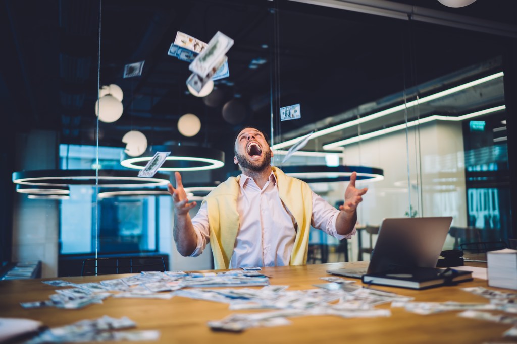 A happy man with money fell beside him.